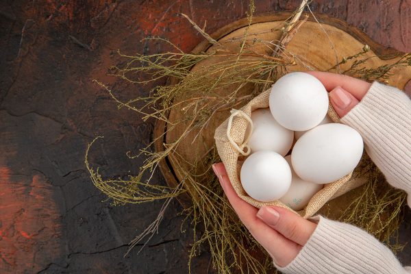 top view chicken eggs inside little bag on a dark background meal color photo food healthy life farm animal